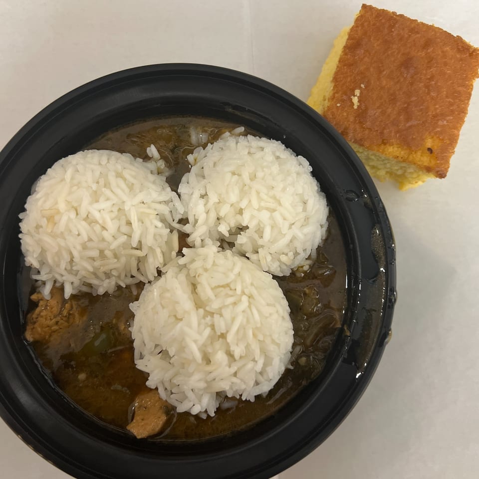 C & E Southern Bites' gumbo with three scoops of rice and a side of cornbread.