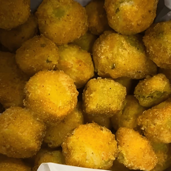 Close-up of golden-brown, breaded fried okra, a classic Southern appetizer from C & E Southern Bites.